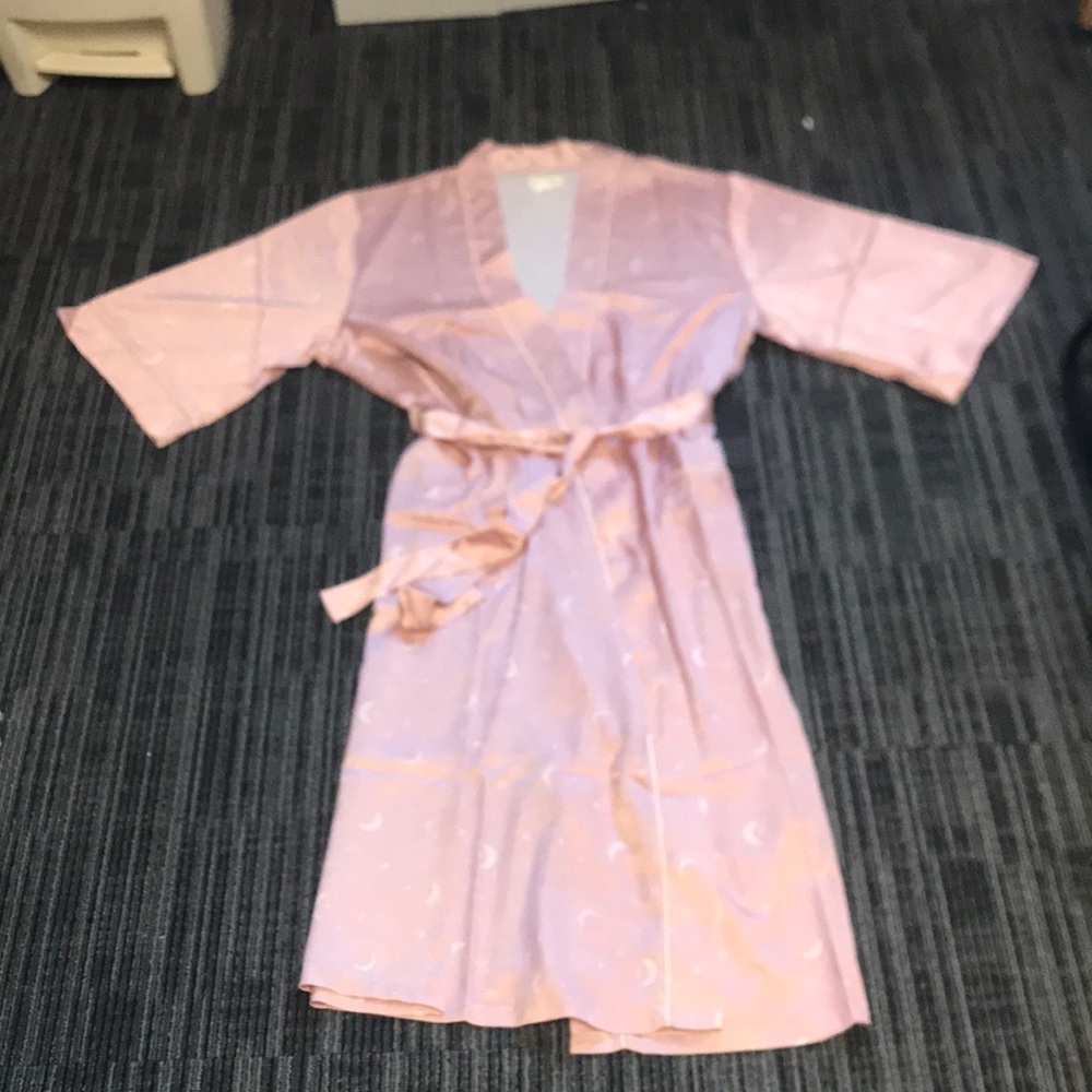 Silky smooth pink bathrobe with white moon and star decorations